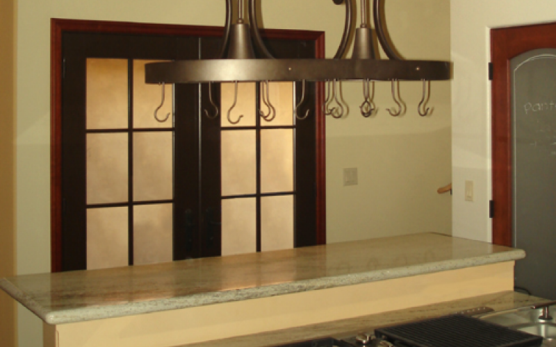 Remodeled kitchen with hanging rack